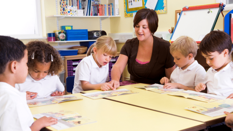Teacher with 5 diverse students reading