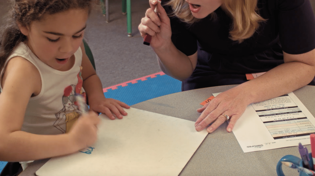 Child and Marnie Ginsberg having fun with activities