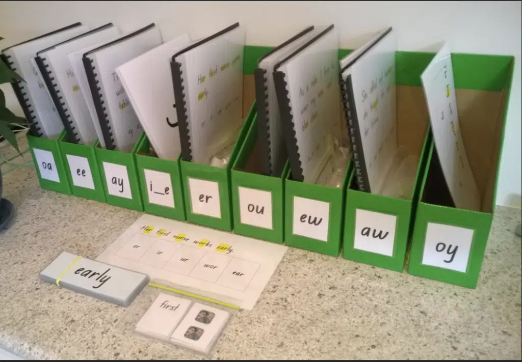 Magazine storage boxes lined up on counter holding Advanced Phonics materials