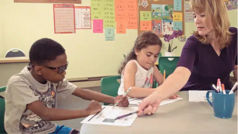Marnie Ginsberg working with small group of students and pointing to Sort It word list.