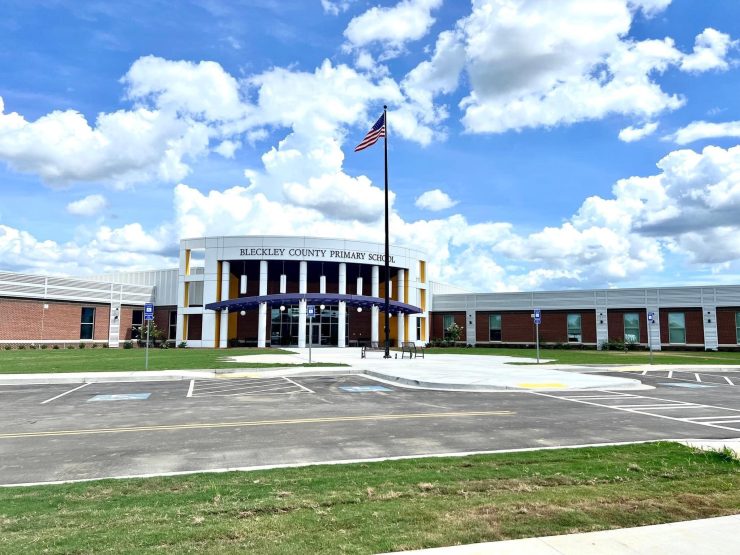 Bleckley Primary Picture of Bleckley County Primary School from the sidewalk with parking, front entrance and US flag